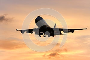 Silhouette of jumbo jet in flight.