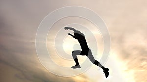 Silhouette of jumping boy against sky