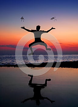 Silhouette jumping man and tossing stone