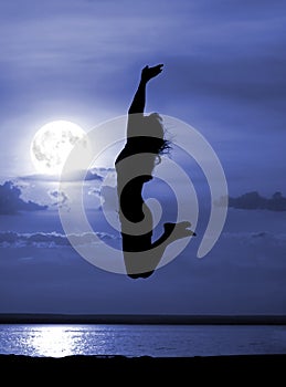 Silhouette jumping women on moon night