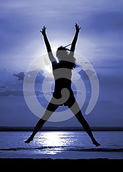 Silhouette jumping women on moon night