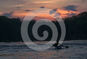 Silhouette of kayaker at sunset