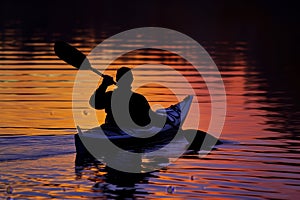 silhouette of a kayaker at sunset, water reflecting colors