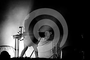 Silhouette of a keyboardist in stage lights