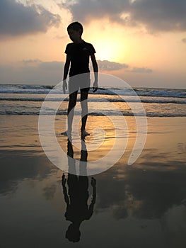 Silhouette of kid on the beach
