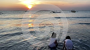 Silhouette of Kids playing in beach touching the waves