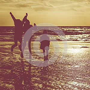 Silhouette of Kids Playing on Beach in Winter