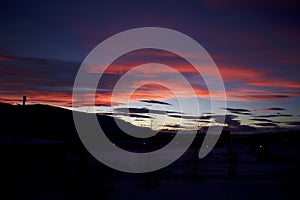 Silhouette of Kiruna iron ore mine with pink twilight sky in the background