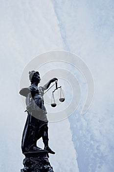 Silhouette of Lady Justice at the fountain at Romerberg in Frankfurt