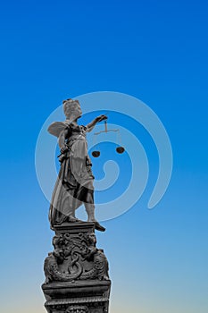 Silhouette of Lady Justice at the fountain at Romerberg in Frankfurt