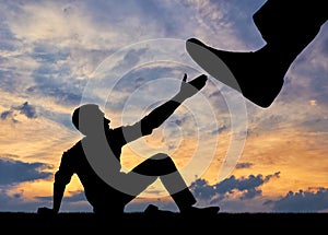 Silhouette of a large leg pressing on a man asking for help