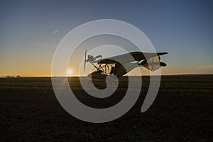 silhouette of a light aircraft on the ground at sunset. travel concept
