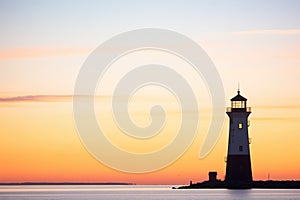 silhouette of a lighthouse at twilight