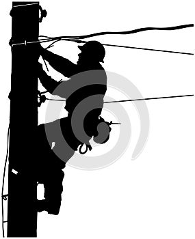 silhouette of a lineman working on an electrical pole