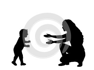 Silhouette of little son taking the first steps towards his mother