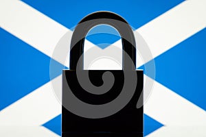 Silhouette of lock against flag of Scotland
