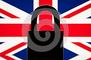 Silhouette of lock with Union Jack flag on the background