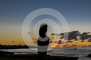 Silhouette of lonely moai at sunset near the marina of Hanga Roa