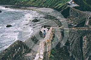 Silhouette of lonely traveller person going up hill