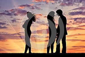 Silhouette of a lonely woman near loving couple