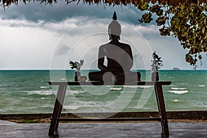 Silhouette of the lord buddha against the backdrop of thunderclouds