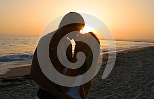 Silhouette Lovers Kissing on tne Beach