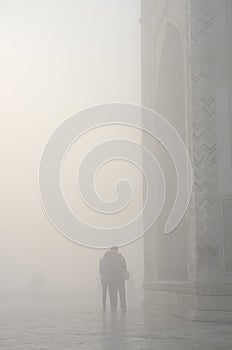 Silhouette of loving couple in a haze ,near Taj Mahal,India