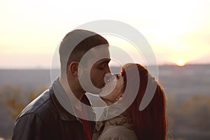 Silhouette of a loving couple kissing on sunset