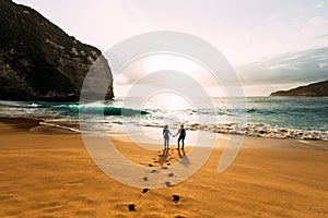 Silhouette of loving couple on sea. A couple in love at sunset. Man and woman meet sunset. Happy loving couple. Silhouette lovers