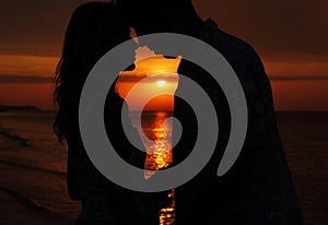 Silhouette of a loving couple at sunset