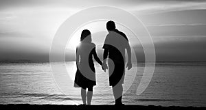Silhouette of a loving couple at sunset on the seashore