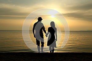 Silhouette of a  loving couple at sunset on the seashore