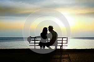 Silhouette of a loving couple at sunset on the seashore