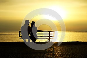 Silhouette of a loving couple at sunset on the seashore