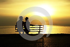 Silhouette of a loving couple at sunset on the seashore