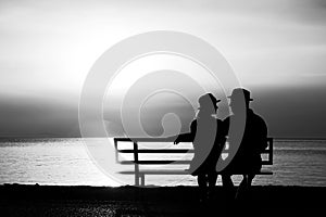 Silhouette of a loving couple at sunset on the seashore