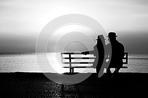 Silhouette of a loving couple at sunset on the seashore