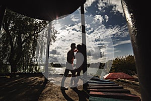 Silhouette of Loving young couple is having fun outdoors. Love and tenderness, dating, romance, family concept