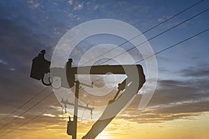 Silhouette maintenance of electricians work with high voltage