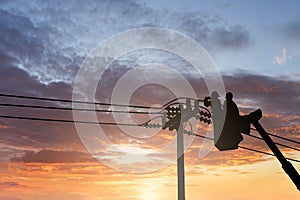 Silhouette maintenance of electricians work with high voltage