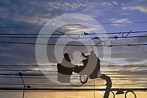 Silhouette maintenance of electricians work with high voltage