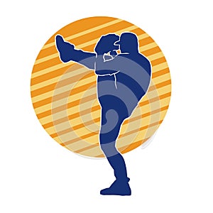 Silhouette of male baseball pitcher in action pose.