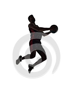 Silhouette of male basketball player in motion during game, training, playing isolated on white background. Full-length