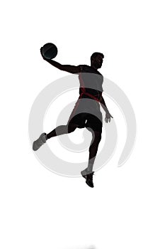 Silhouette of male basketball player in motion during game, training, playing isolated on white background. Full-length