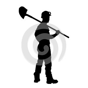 silhouette of a male construction worker digging ground with a shovel.