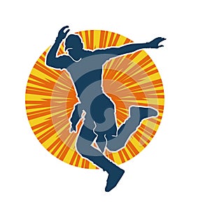 Silhouette of a male dancer in action pose.