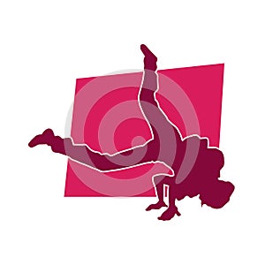 Silhouette of a male dancer doing hand stand pose.