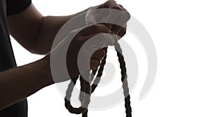 Silhouette of male hands knotted noose neck noose on white isolated background, concept life failure, financial crisis