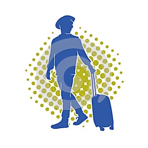 Silhouette of a male traveller with wheeled luggage case.