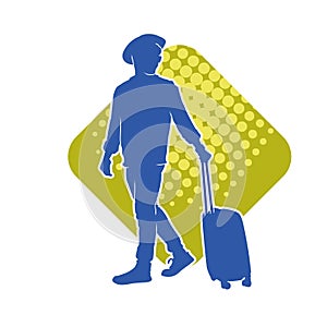 Silhouette of a male traveller with wheeled luggage case.